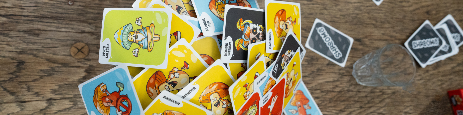 Shroomo card game spread across a wooden table, ready for an alcohol-free sober party game night